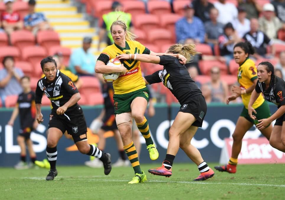 Seeking info: Bega export Kezie Apps - pictured fending a NZ Fern in the World Cup - is eager for more details of the NRL women's draw. Picture: NRL Photos