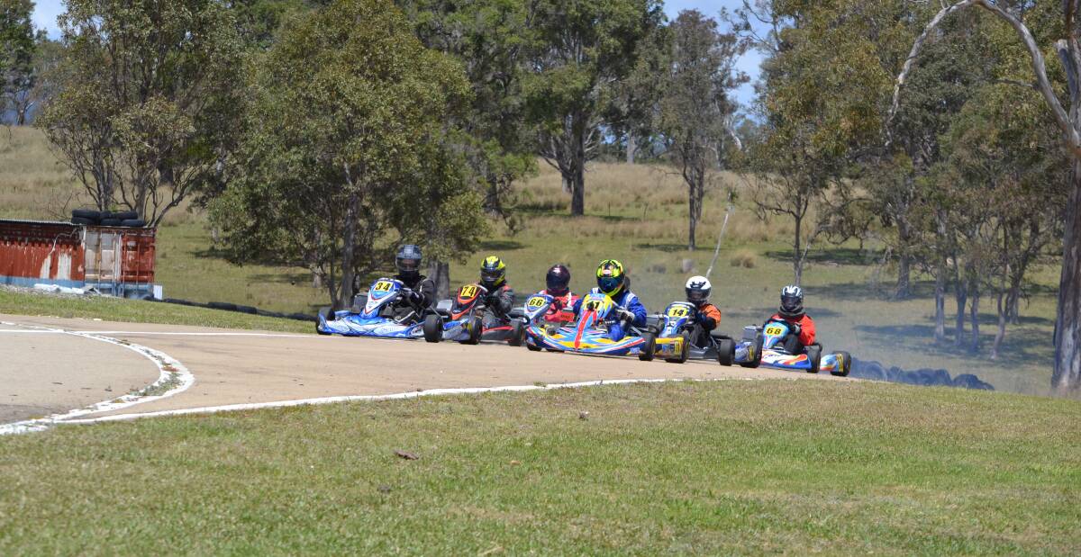 Burning rubber: Go karters hurtle off the line during a recent meet at the Sapphire Coast Kart Club.