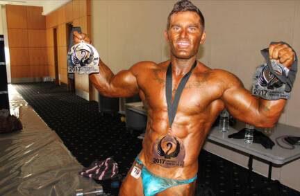 Bodybuilders gleaming on competition stage