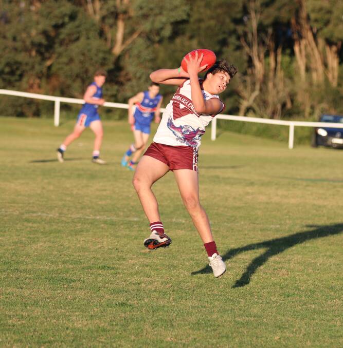 Strong inclusion: Dennis Paratene takes a great mark against the afternoon sun during a clash with the Merimbula Diggers late in 2016. 