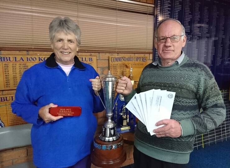 Ladies champ: Merimbula Big Game and Lakes Angling Club president John McKay presents Merrily Bell with her Ladies Championship trophy and fishing prizes for 2016-17.
