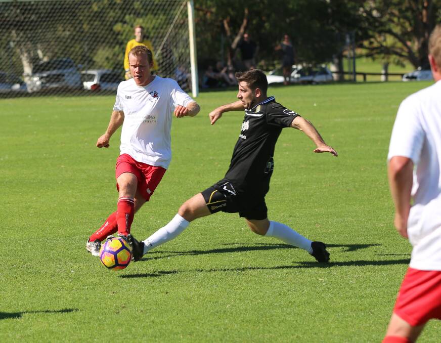 Bega Devil Phil Chapman gets the ball away to a team-mate against the St Patrick's FC at George Griffin Oval on Saturday as part of the FFA Cup. 