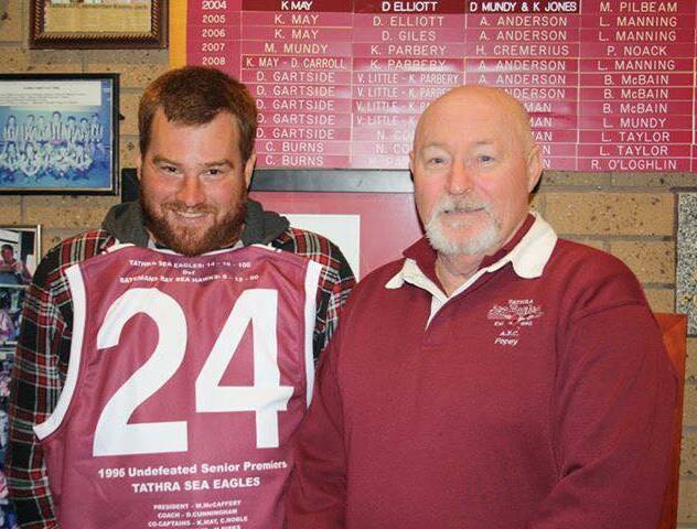 Eagles legacy: Casey Jack is presented his father's number 24 jersey by Robert Pope as part of reunion celebrations last week. 