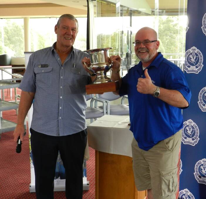 Peter Weir presents the winners' trophy to NSW Ambulance’s David Oliver at the last Emergency Services Golf Day. 