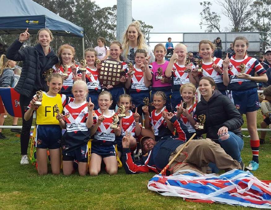 Winners are grinners: The junior league-tag girls celebrate their first rugby league premiership in Eden on Saturday. Picture: Wendy Deighton. 