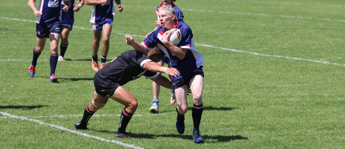 Primed: Bega back Lee Fuller looks to step a tackle attempt by a Cooma Stallion during the Nines tournament. 