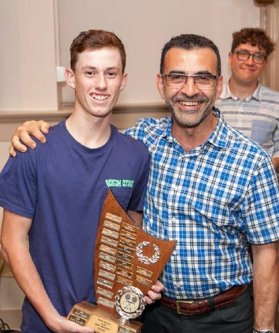 Most improved: One of the rising talents in the Bega Squash Club, Ryan Galeano is congratulated by club president John Stylianou. 