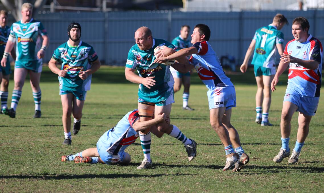 Tackle: A pair of Roosters combine to bring down Trent Rollason from the Candelo-Bemboka Panthers during a heated reserve grade contest.
