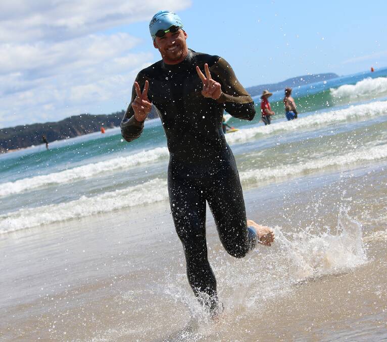 Shayne Rettke is all smiles as he emerges from the water in his age swim of the Wharf to Waves.