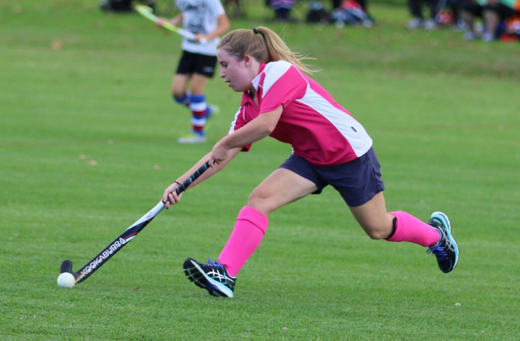 Emma Roberts makes a strong run toward the Grand Hotel defensive lines during the Sapphire Coast Hockey Association season opener on Saturday. 