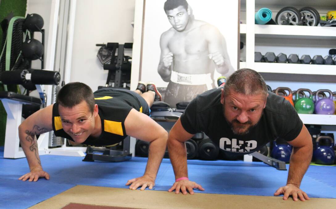 Push ups with purpose: Phil Martin and Adrian Day hope to help PTSD sufferers through talk and exercise on Saturday. 