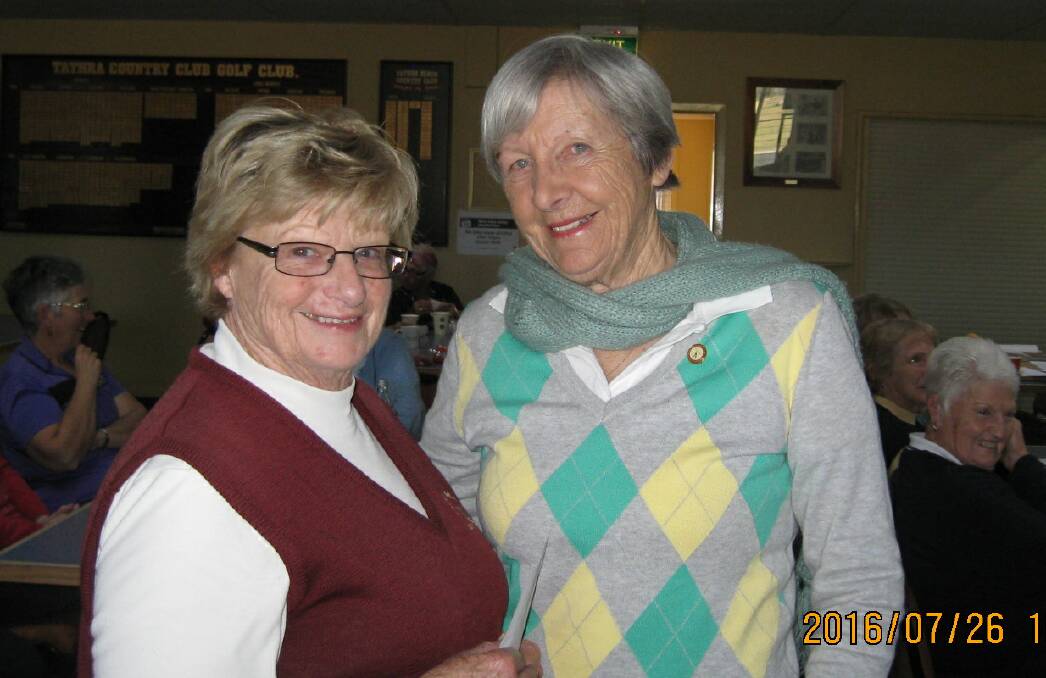 Tathra Beach ladies golf vice-captain Trish Westmore congratulates Tuesday monthly medal winner Lou Holt.