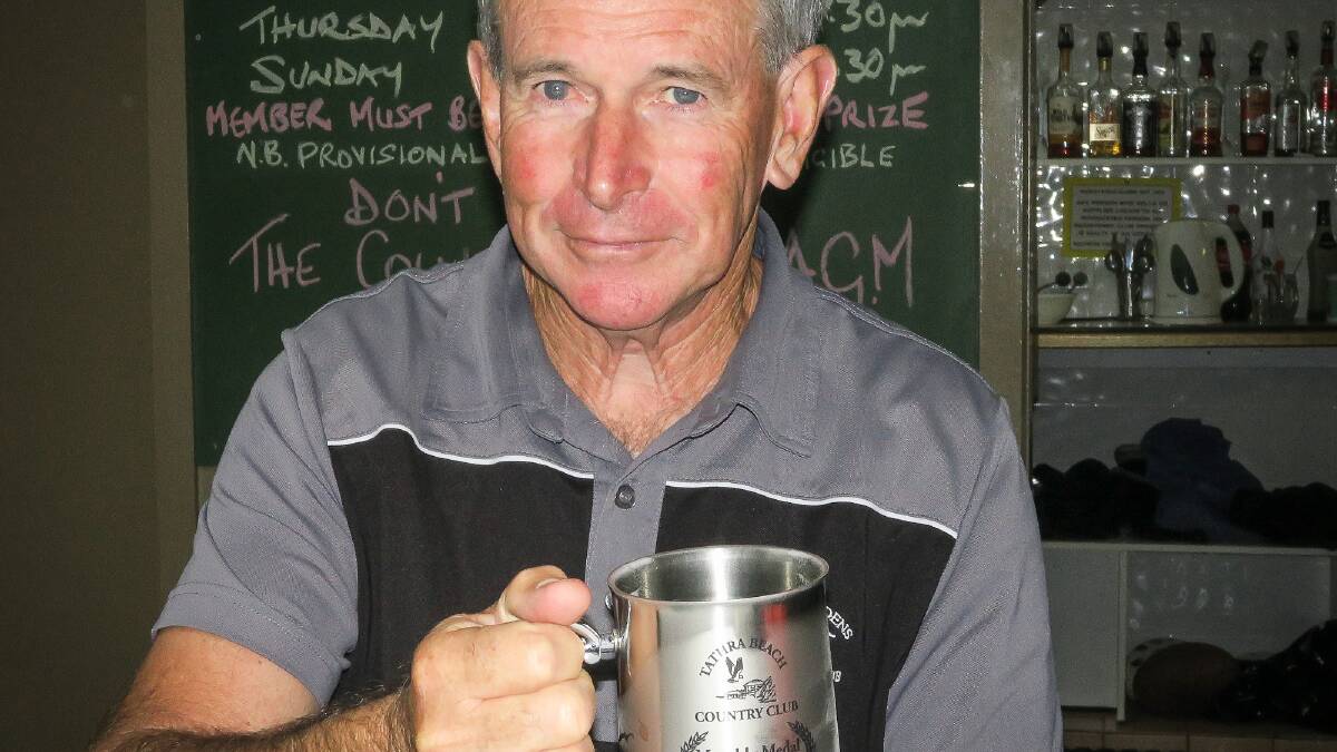 Cheers to that: Ron Thornton holds the mug for winning the Tathra Beach Country Club men's golf December medal. 