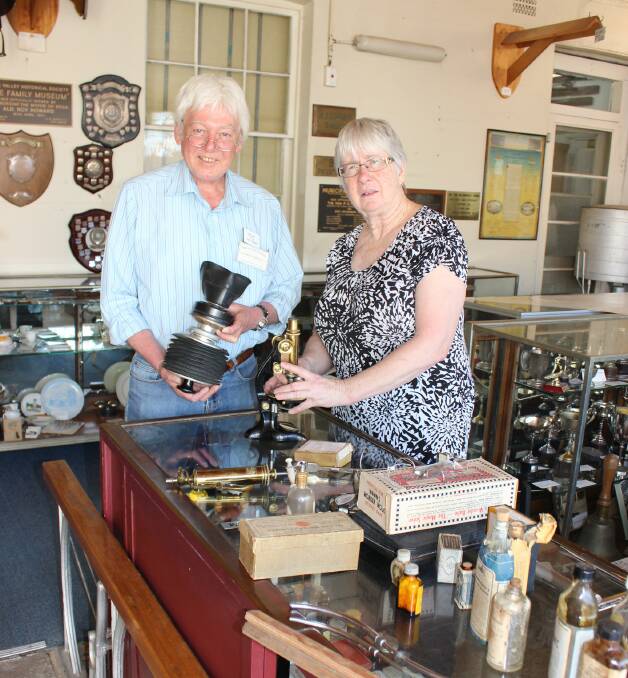 History on show: Graham Farram and Kaye Jauncey choose hospital items from the Bega Pioneers' Museum collection to be shown at the Roof Spring Festival on Sunday.