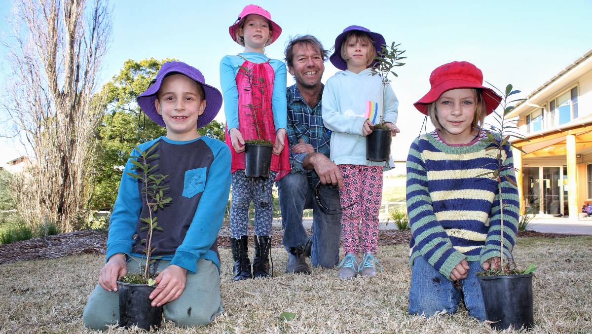 TREE DAY: Mumbulla School for Rudolf Steiner Education pupils Levi Bobeldyk, Mali Everett, Fern Cross and Axel Beattie with building and grounds caretaker Jason Armstrong ahead of Schools Tree Day. Picture: Alasdair McDonald
