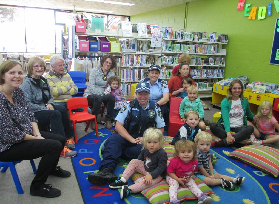 LEARNING: Police officers Karen Nelligan and Sarah Bancroft read to preschoolers in the Bega Library on Thursday. The children are Billie Finnegan, Cormac Ryan, Judd Mackey, Arlo, Riley, Isla Sweeny and Juniper.
