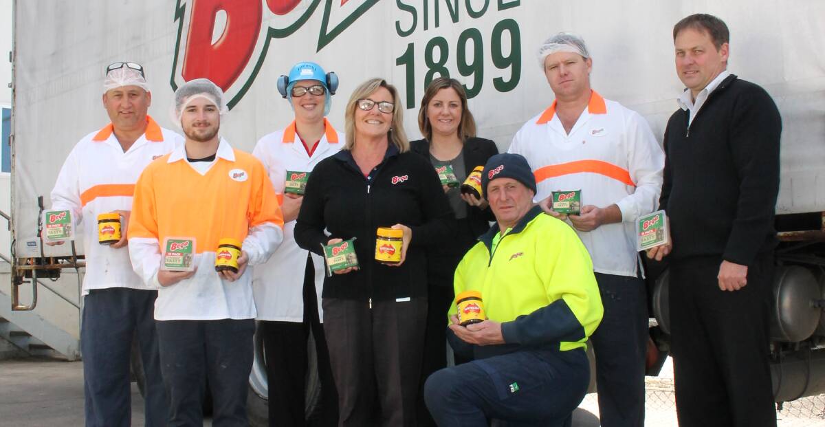 Bega Cheese factory workers pose with their new product. Left to Right: Zac Spurling, Leonie Balcomb, Mary Rankin, Bega Valley Shire Mayor Kristy McBain, Ben Kirby, Shawn Kennedy and Leon Garner. Picture: Alana Beitz