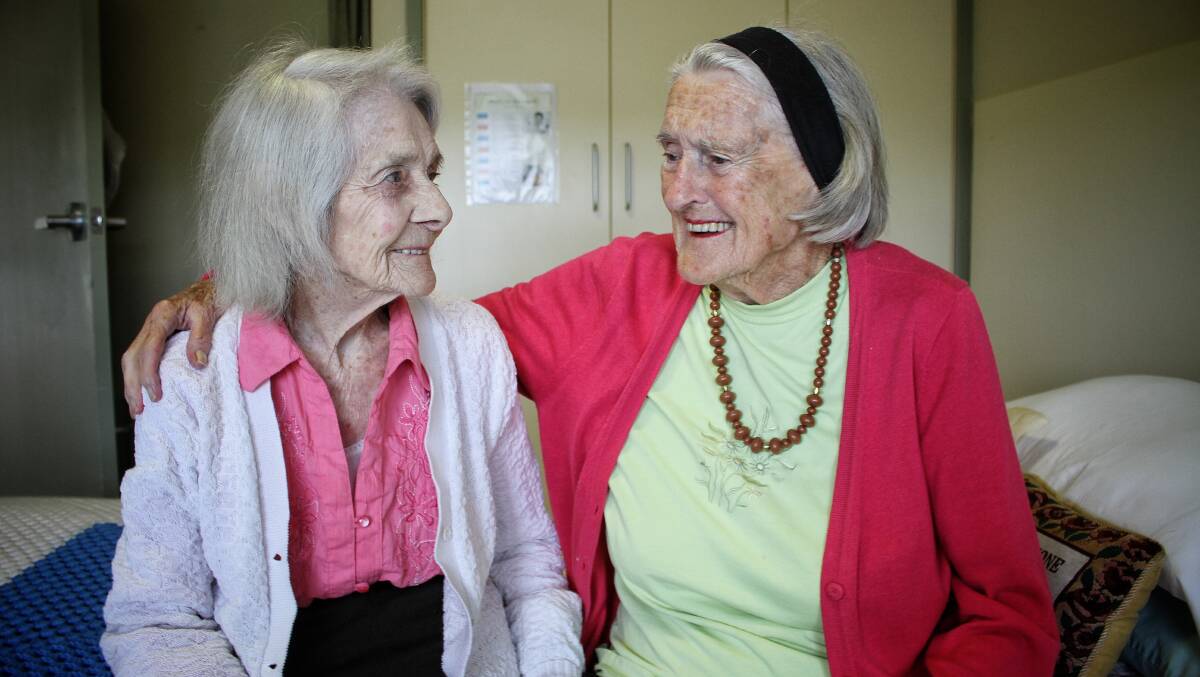 REUNITED: Ninety-nine-year-old May Edmunds and 93-year-old Val Clark share a smile over 80 years since they first met. Photo: Alasdair McDonald