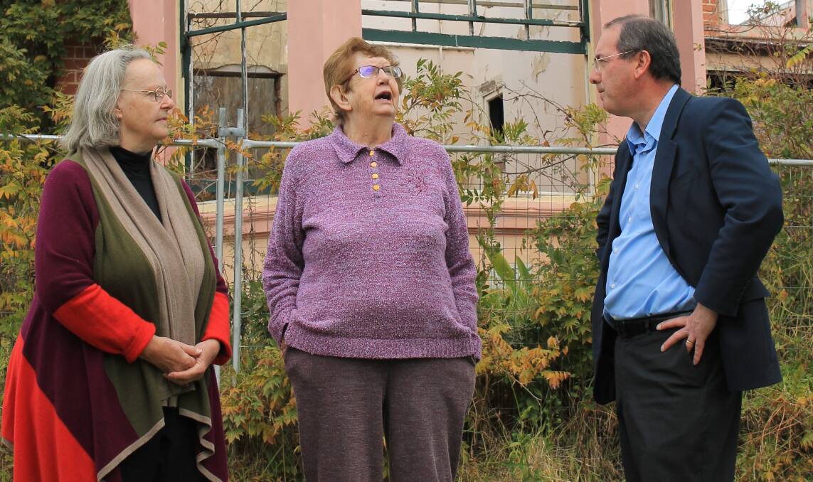 THANKFUL: Trustees of the Old Bega Hospital Reserve Trust Pat Jones and Claire Lupton meet Peter Hendy outside the burnt part of the hospital. Picture: Albert McKnight