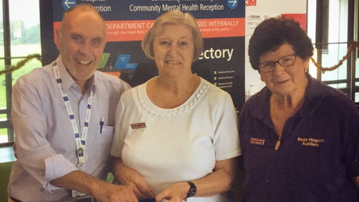 Dr Don Cave draws the Bega Hospital Auxilairy's Christmas raffle with Valerie Hobbs and Anne Sheedy. Picture: Supplied