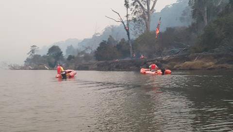 SMOKY SCENES: Lifesavers patrol the Bega River on March 18. Picture: Donald Hay.