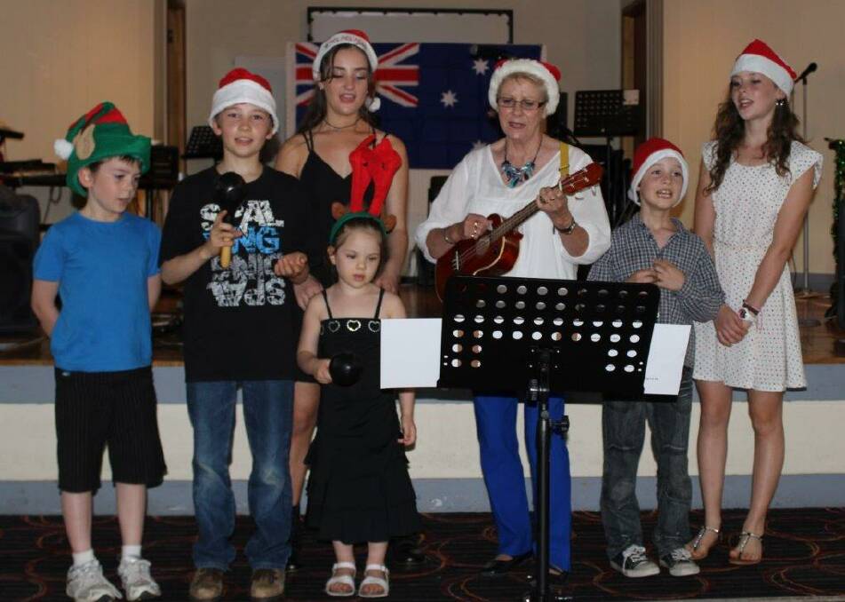 Free concert: Lori Hammerton (on ukulele) joined a group of Bermagui children to entertain the audience at Bermagui Country Club on Sunday.  