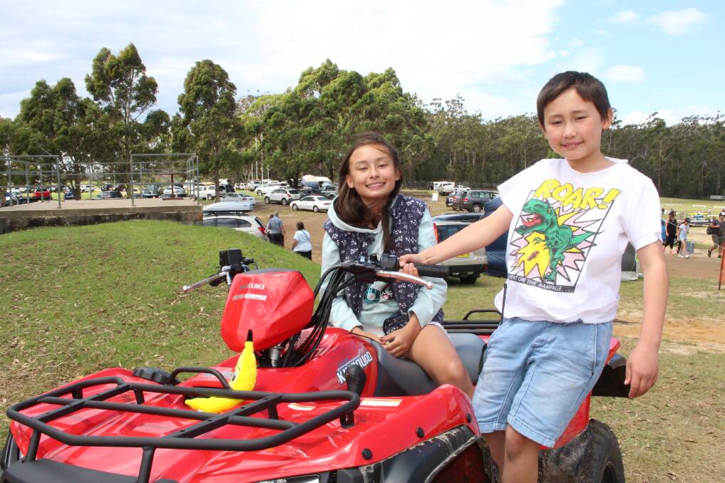 Showtime!: Daytona and Austin Porter of Tathra enjoy the activities still on offer at the rain-affected Pambula Show on Saturday.
