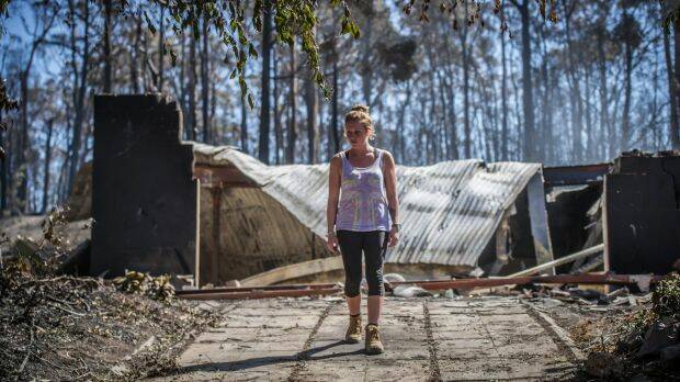 Juvette Jory looks at the rubble of her family home in Tathra: It was a horrifying experience, just like a movie. Photo: Karleen Minney
