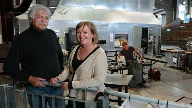 Canberra Glassworks founder Klaus Moje with general manager Beverly Growden as artist Sophia Emmett works in the hotshop. Photo: Jeffrey Chan
