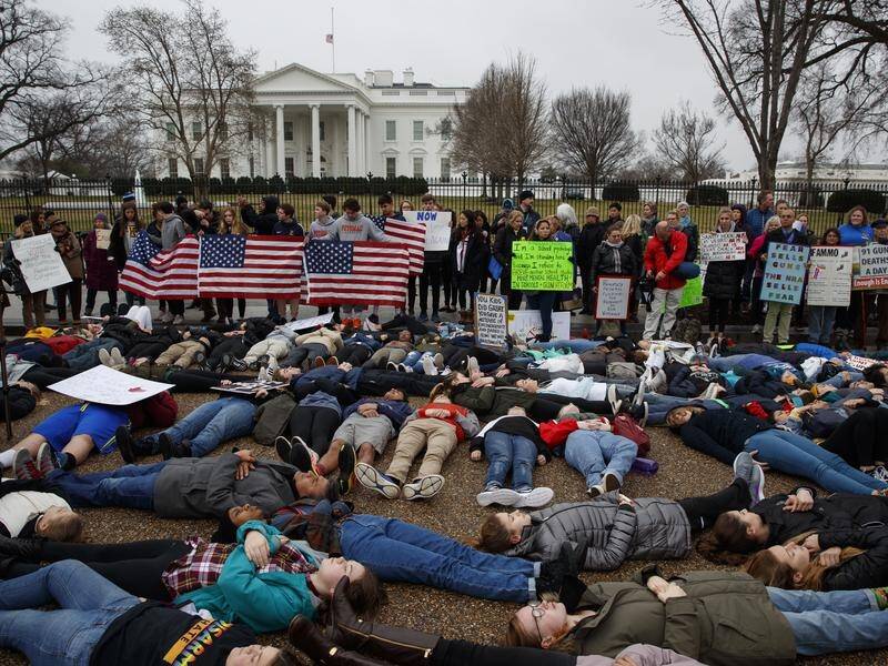 Dozens of teenagers have held a "lie-in" outside the White House demanding gun control reform.