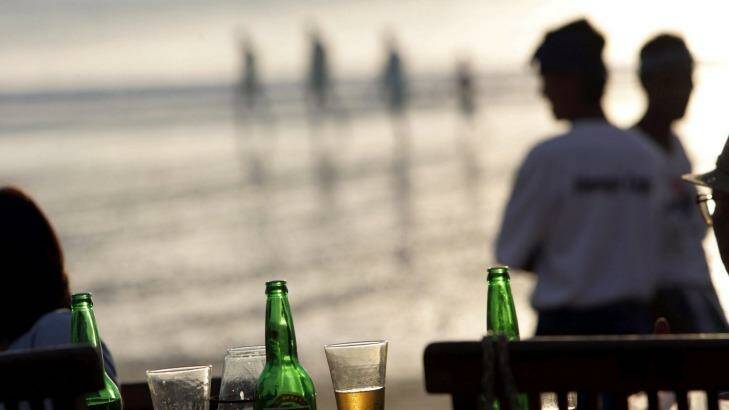 Japanese tourists enjoy a sunset beer at the Menega Fish Cafe in Jimbaran Bay. Photo: Jason Childs