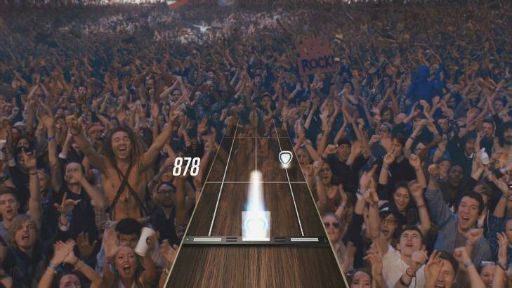<i>Guitar Hero Live</i> is played from a new first-person view, and features real footage of a crowd and bandmates who react positively when you're doing well ... Photo: Activision
