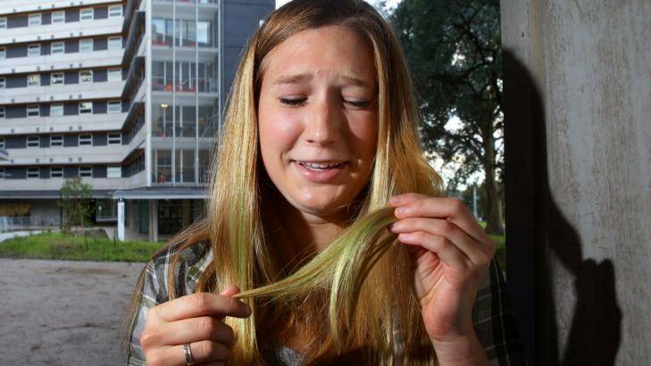 Desperate measures: Melissa Brueckner inspects her damaged hair. Photo: Peter Stoop