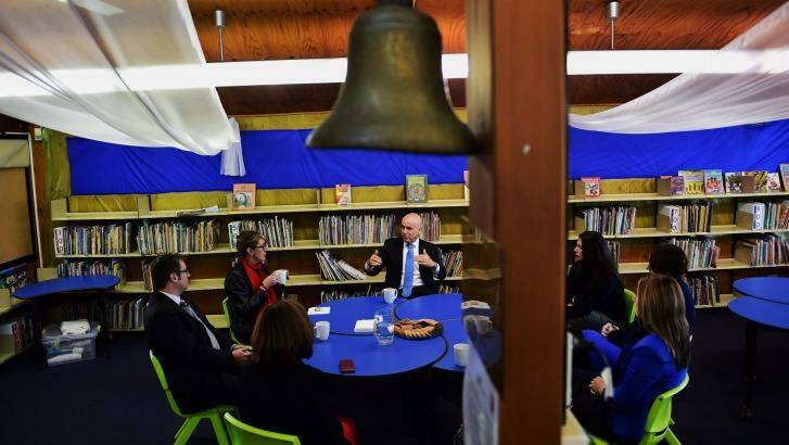 Education Minister Adrian Piccoli speaks to the principal and teachers at Villawood North Public School amid concerns about Gonski funding. 
 Photo: Nick Moir