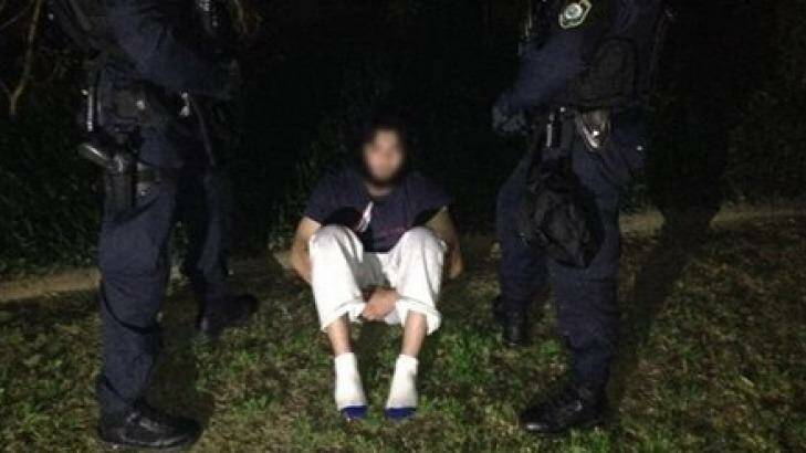 Handcuffed: One of the terrorism suspects early onThursday. Photo: NSW Police Media Unit