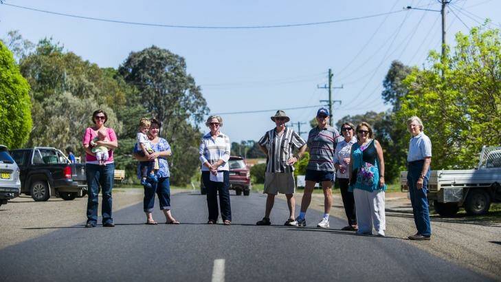 Gundaroo residents who oppose two proposals for residential development on either side of the village, standing on the main road. Photo: Rohan Thomson