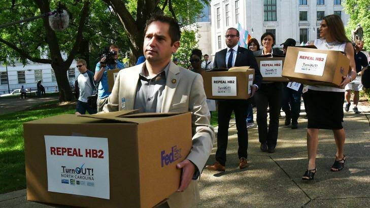 The executive director of Equality North Carolina, Chris Sgro, leads a group carrying petitions calling for the repeal of House Bill 2 to governor Pat McCrory's office. Photo: News & Observer/AP