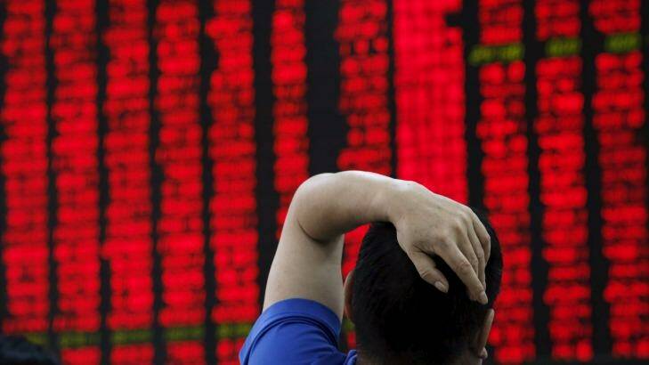 Sea of red: A man watches a board showing stock prices at a brokerage office in Beijing. Photo: Kim Kyung-Hoon/Reuters