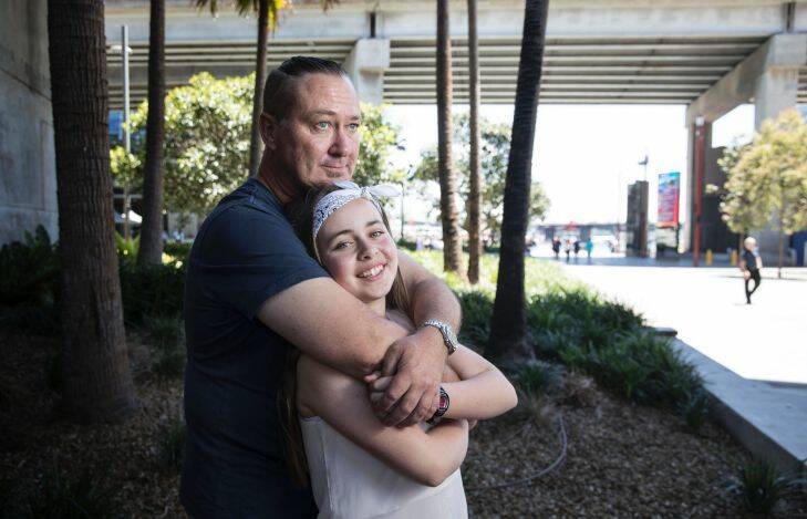 Ian Cant with his 12 year old, Demi Ann Cant by the Sydney International Convention Centre at Darling Harbour, Sydney on 15 November 2017. Photo: Jessica Hromas
Ian Cant is has undergone immunotherapy and has had a great result. He is an ex-Police sergeant who retired after experiencing PTSD and then later discovered he had melanoma throughout his body. He very lucky to have had a great response to immunotherapy, but is coping with the psychological impact of living from three months to three months waiting to get scans and see what happens next.