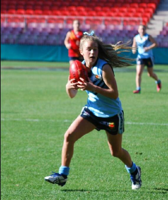 Bega Valley Aussie rules star Dakota Hooper takes a contested mark for NSW against South Australia, during a match where she was named best on ground at the recent national school championships in Sydney.