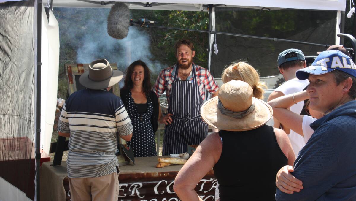 Amanda Thompson from Symphony Farm and River Cottage Australia TV host Paul West are filmed in action at their food stall.