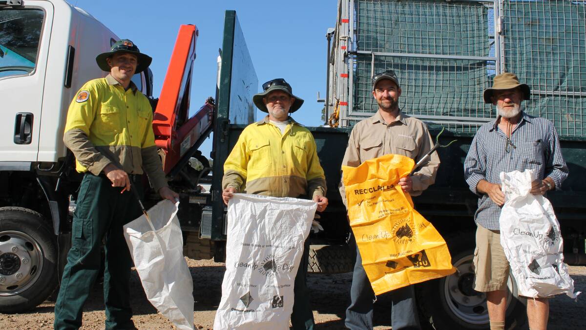 NPWS staff Simon Conaty and Darryl Bills, Luke Brown of the Bournda Environmental Education Centre and community volunteer Bob Brown during their clean-up of Sapphire Coast Drive last March.