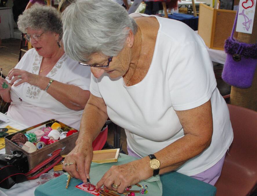 Rita Roberts makes lace in the Bega Showground pavilion.