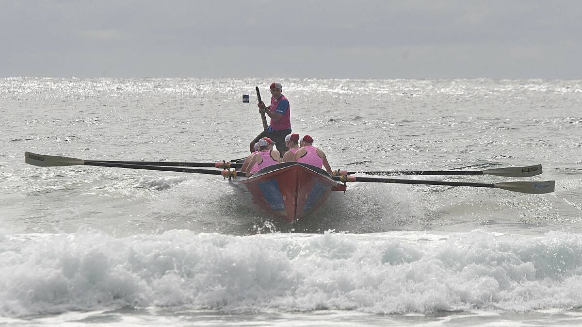 The Tathra women’s surf boat crew finally gets a smooth run through the break.