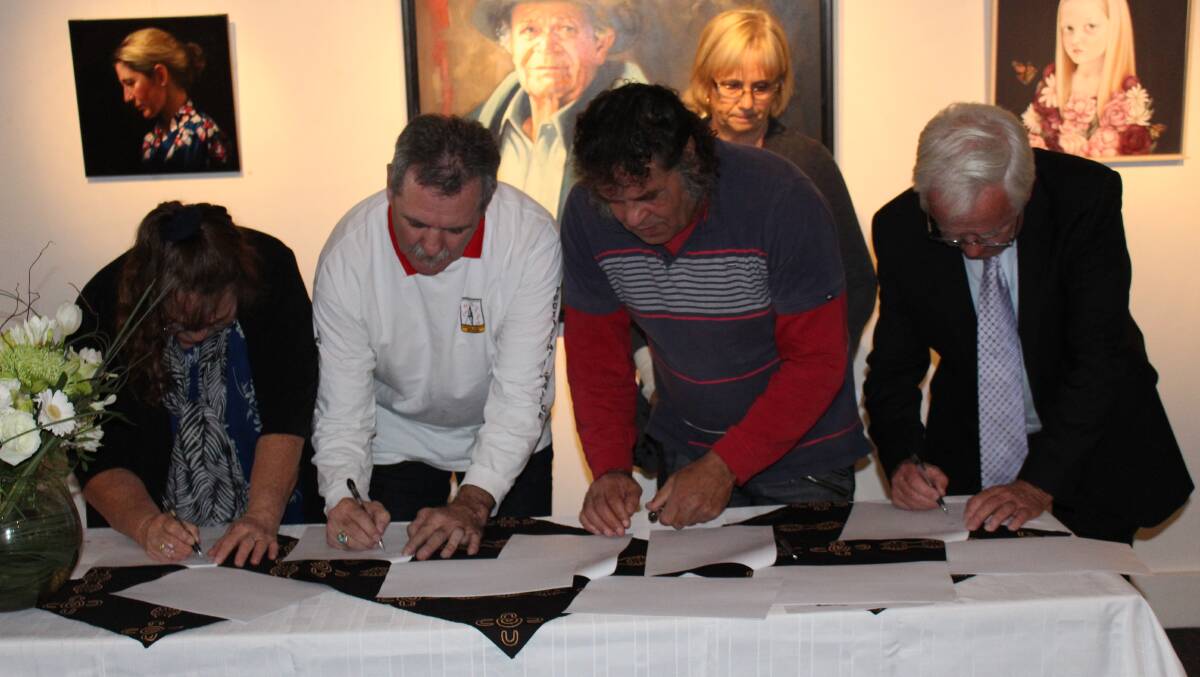 Bega Valley Shire Mayor Bill Taylor and representatives of the three Local Aboriginal Land Councils sign a Memorandum of Understanding.