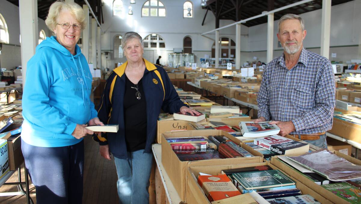Bega Rotary members (from left) Jan Southcott, Beth Walters and Charlie Blomfield set up books for the book fair, held in the Bega Showground pavilion.