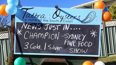 Tathra Oysters celebrated its success at the Sydney Fine Food Aquaculture Awards with a home-made sign at their Tathra store.
