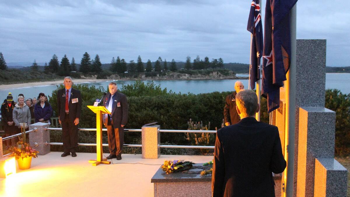 Members of the Bermagui RSL give a minutes silence.