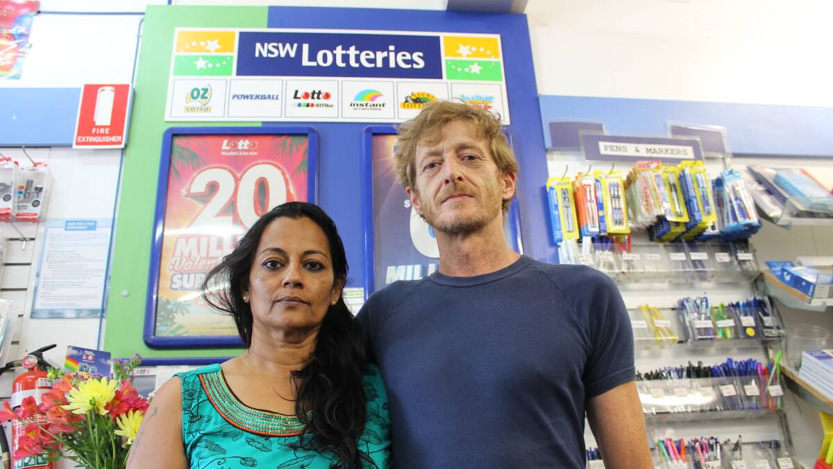 Bermagui South Newsagency owners Nandini and Martin Hunter Jones stand in front of the lottery table in their shop.