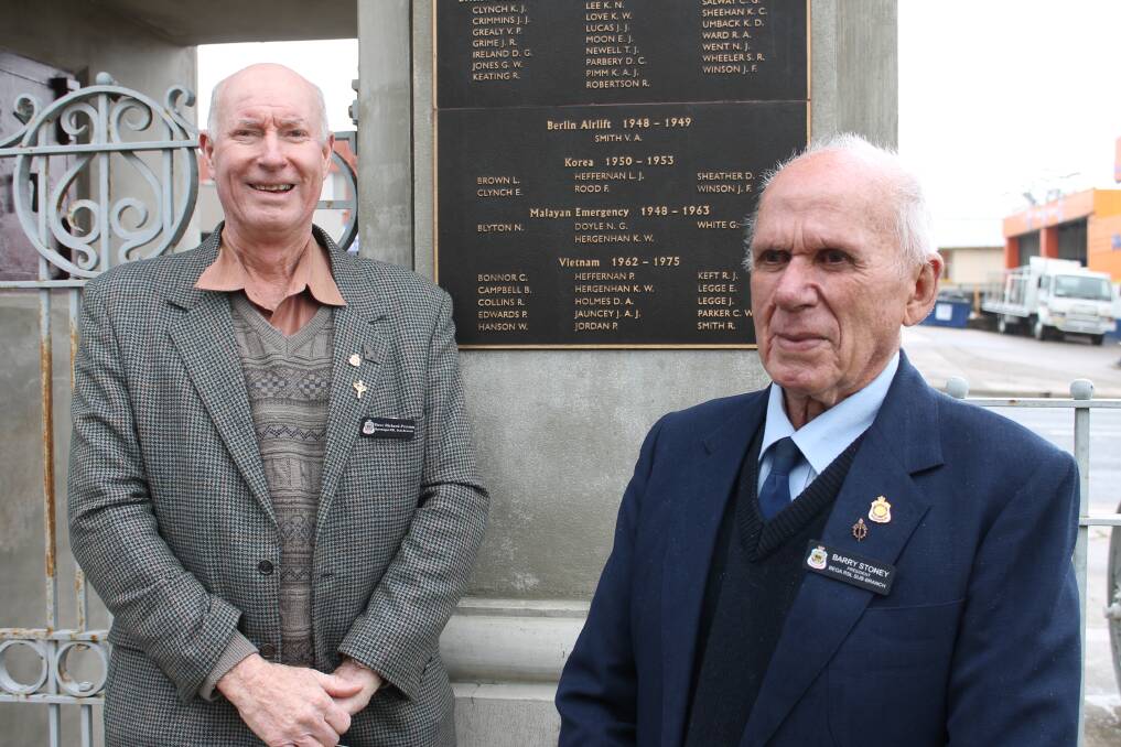 Dave Richard-Preston with Bega RSL sub branch president Barry Stoney next to the Bega Vietnam War memorial plaque.